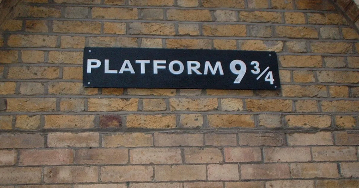 The Platform 9 3/4 sign on a brick wall at King's Cross station, a stop on a Harry Potter black cab tour